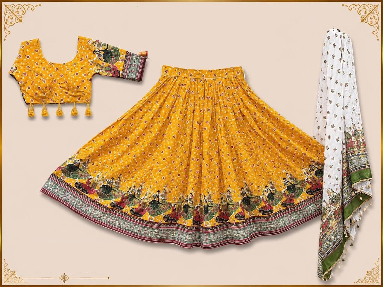 Mustard bandhani-print skirt with a border of printed garba dancers, matching tasselled blouse and a white printed dupatta
