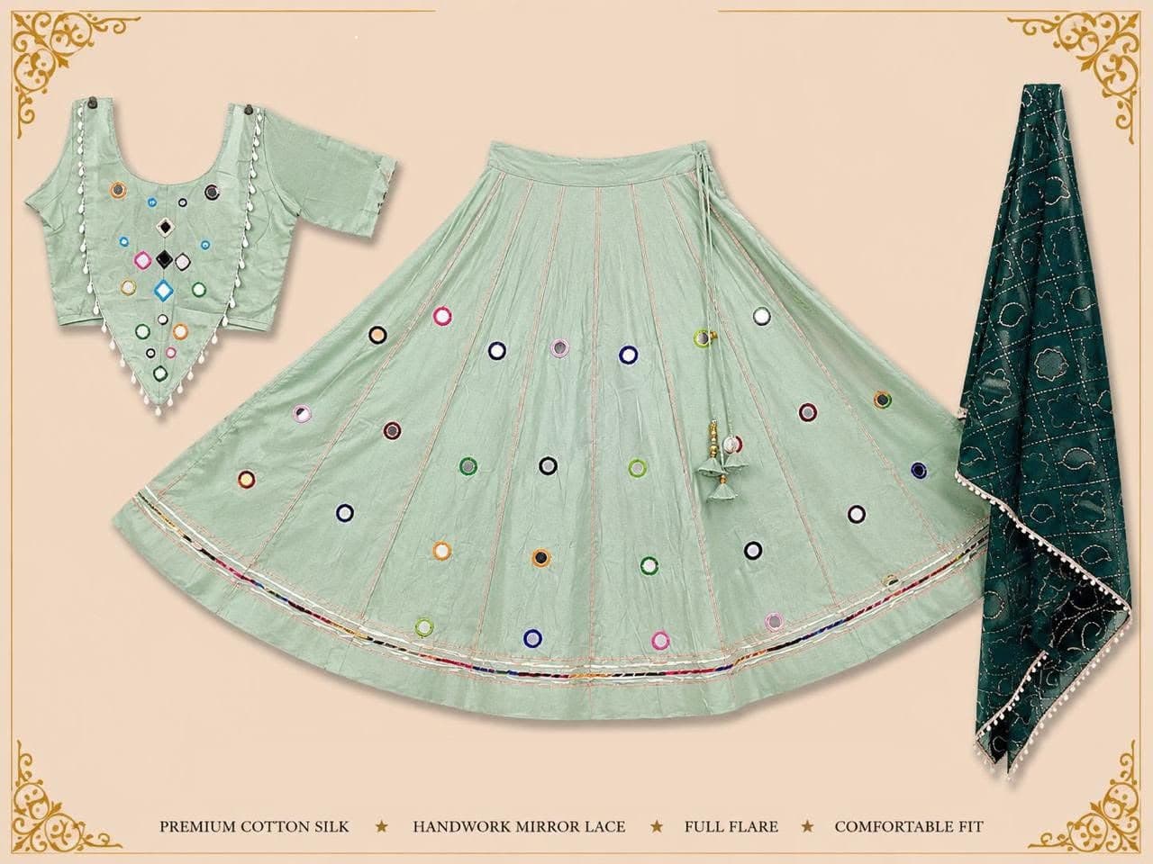 Pastel sage-green skirt scattered with round mirror work, V-hem mirror blouse with white drops and a bottle-green printed dupatta
