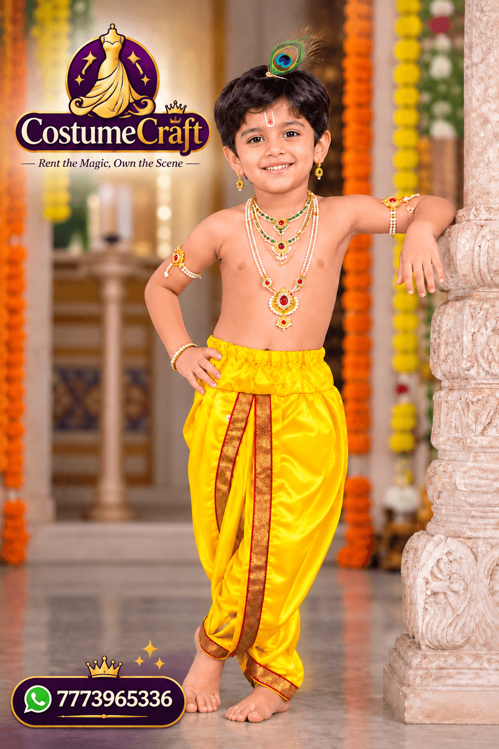 Young boy in a yellow silk Krishna dhoti with a peacock-feather crown and pearl jewellery, standing in a temple courtyard